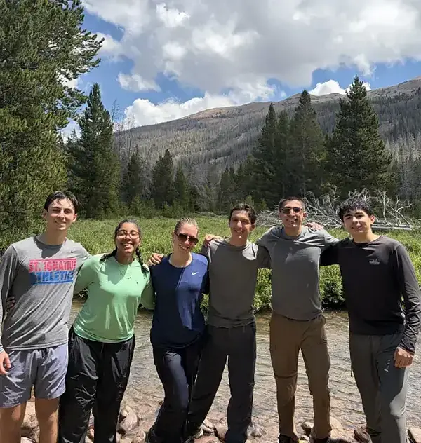 LSSP 10 WONDER: Six people pose for a photo in a mountainous, wooded area.